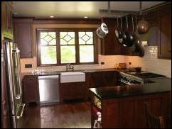 Renovation of the kitchen in this turn of the century home included a new window, warm cherry cabinets, handmade tile, and soapstone countertops. Appliances used are by Jenn Aire, Asko, Wolf, and Vent a Hood